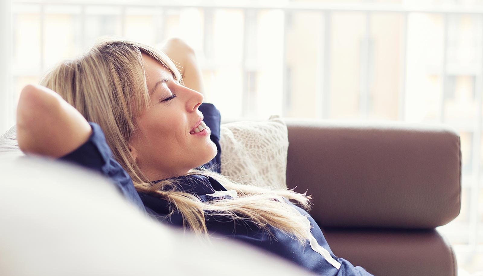 a lady relaxes on the sofa in her hotel room